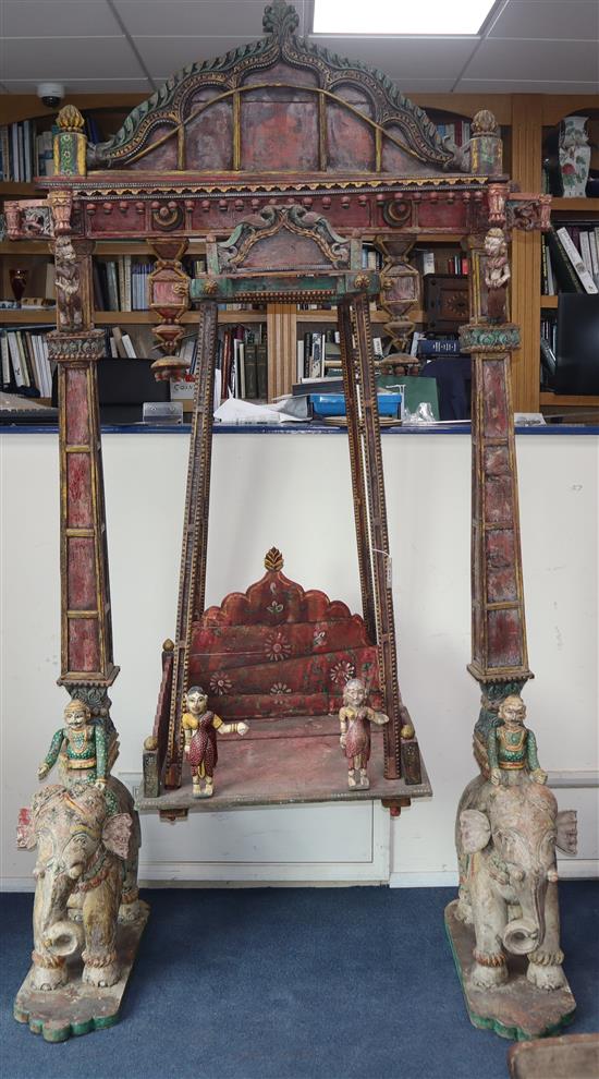 An impressive Indian carved polychrome wood swing, Jaipur W.approx. 140cm, H.approx. 247cm